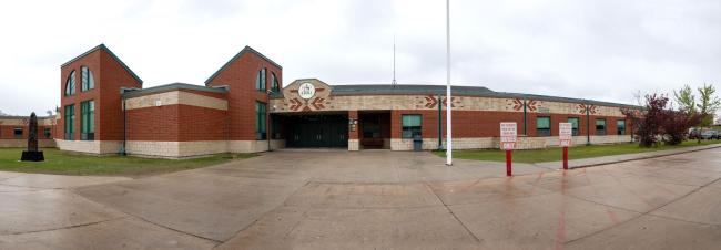 Dunseith Day School buses only signs out front.